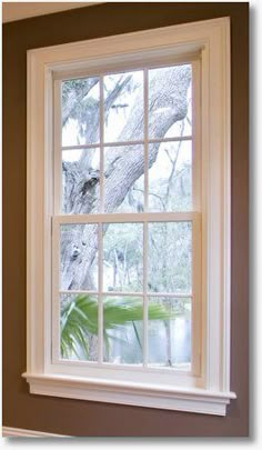 an open window in a house with trees outside