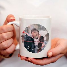 a person holding a coffee mug with a photo on it