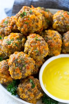 a white plate topped with meatballs and dipping sauce