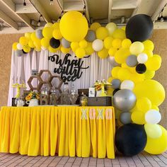 a yellow and black party with balloons