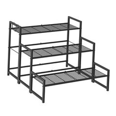 three tiered metal shelving unit on white background