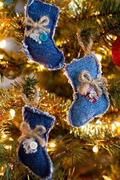 christmas ornaments hanging from a tree with blue and red decorations on it's branches