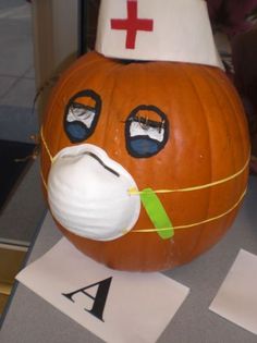 a pumpkin with a nurse's hat on it