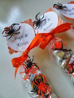 candy wrapped in cellophane and decorated with spider webs for halloween party favors