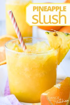 a pineapple slush is garnished with an orange slice and a striped straw