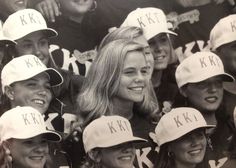 a group of women in baseball caps posing for a photo