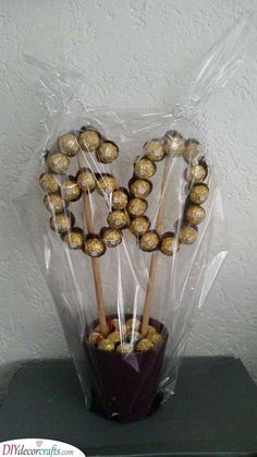 a bouquet of chocolate covered pretzels wrapped in cellophane and sitting on top of a table