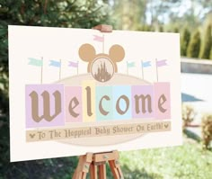 a welcome sign is displayed on an easel