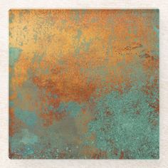 an old rusted metal surface with green and orange colors