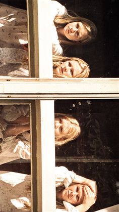 two women are looking out the window together