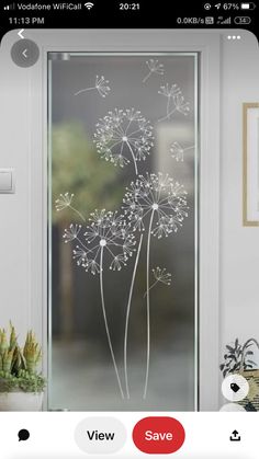 a glass door with dandelions drawn on it