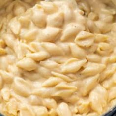 macaroni and cheese is being stirred in a pot