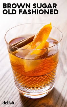 an old fashioned drink in a glass on a wooden table