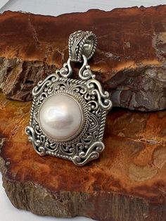 This is a beautiful Sarda Sterling and pearl  pendant  , size shown in pics. Definitely a statement piece , can fit on a large style chain Ornate White Pearl Pendant Jewelry, White Pearl Necklace With Large Pendant, Handmade Elegant Pearl Necklace With Round Pendant, Elegant Pearl Necklace With Large Pendant As Gift, Elegant Pearl Necklace With Large Pendant, Elegant Handmade Pearl Necklace With Round Pendant, Elegant White Necklace With Large Pendant, Elegant White Necklaces With Large Pendant, Pearl Pendant