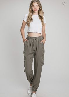 Super trendy silky soft drawstring cargo joggers are a must have for this fall! These olive joggers are perfect to dress up or down for any event this fall season. These are 100% Polyester for a comfy true to size fit. In Stock and ready to ship Spring Cargo Style Sweatpants, Spring Solid Color Cargo Sweatpants, Trendy Cargo Style Sweatpants For Loungewear, Spring Cargo Style Sweatpants For Loungewear, Trendy Spring Joggers With Cargo Pockets, Spring Cargo Style Relaxed Fit Joggers, Spring Athleisure Cargo Pants For Loungewear, Casual Olive Cargo Pants For Fall, Khaki Cargo Pants With Side Pockets For Loungewear