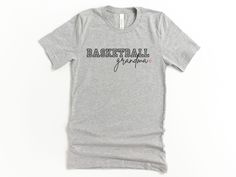 Cute Basketball Grandma Graphic Tee * Bella + Canvas soft fabric T-shirt * Unisex adult sizing * Direct-to-Garment printed item that will not peel like vinyl Care Instructions: *Wash item inside-out in cold water on gentle washing cycle *Dry on low heat or let air dry  *Do not iron directly onto the design *Please review the product photos for available styles, size, shirt colors and other details such as font color  ❤️ Thank you for supporting my small business! Funny Grandma Shirts Basketball, Grandma Tshirt, Toddler Graphic Tee, Mom Graphic Tees, Sports Mom Shirts, Wrestling Mom, Cute Graphic Tees, Game Day Shirts, Fan Shirts