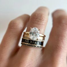 a close up of a person's hand with a ring on it and a diamond in the middle