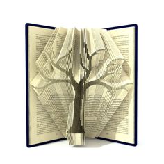 an open book with a tree cut out of it's pages on the inside