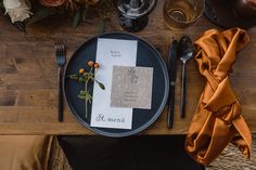 the table is set with silverware, napkins and place settings for an elegant dinner