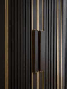 a black and gold striped wall with an open door