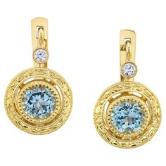 These aquamarine and diamond drop earrings are such a "go-to" style! Two brilliantly blue, round aquamarines are bezel set in 18k yellow gold framed by floating halos that have been handcrafted and intricately engraved. A single bezel set diamond sparkles atop each aquamarine. These earrings dangle just below the earlobe, putting the finishing touch on casual, business, or evening attire! Part of our Day to Night Collection, this look is timeless! Handmade in 18k yellow gold by our Master Jewelers in Los Angeles. Earrings measure approximately 3/4-inch in length and 3/8-inch in diameter Aquamarines, 5.50mm, 1.14 carats total Diamonds, .08 carats total Multicolor Jewelry, Horse Earrings, Coral Earrings, Valley Wedding, Bezel Set Diamond, Diamond Drops, Blue Zircon, Contemporary Jewellery, Diamond Drop Earrings