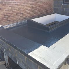 a flat roof is being installed on a brick building