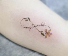 a small tattoo with the word impplaceable written in cursive writing