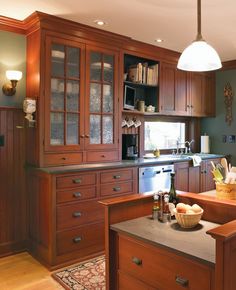 a kitchen with wooden cabinets and counter tops