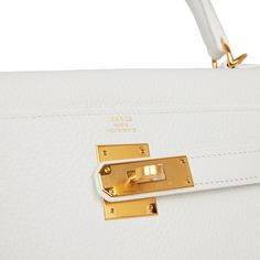 This is a payment 1 of 2 for PH--total of the bag is $27500 This Kelly, in the Retourne style, is in White clemence leather with gold hardware and has tonal stitching,front flap, two straps with center toggle closure, clochette with lock and two keys, single rolled handle and removable shoulder strap. The interior is lined in white chevre and has one zip pocket with Hermes engraved pull and two open pockets on the opposite side.Collection: YOrigin: FranceCondition: Pristine; new or never (plasti Hermes Kelly Retourne, Hermes Box, Tote Handbags, Gold Hardware, Zip Pockets, Dust Bag, Fendi, Shoulder Strap, Stitching