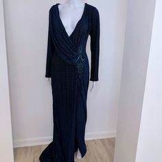 a mannequin is dressed in a long blue dress