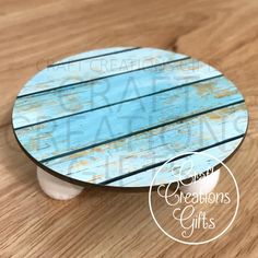 a blue and white wooden plate sitting on top of a table