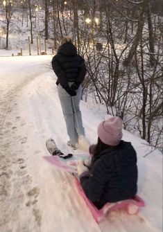 two people riding skis down a snow covered slope