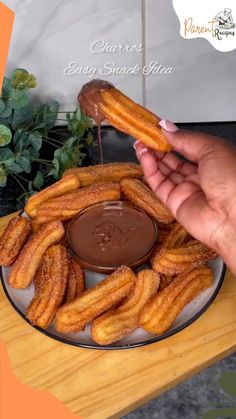 someone is dipping sauce on some churros