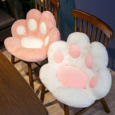 two chairs with paw prints on them sitting next to each other in front of a table