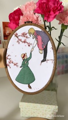 a hand embroidered picture of a man holding a woman's arm with flowers in the background