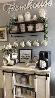 a white cabinet with coffee cups and mugs on it in front of a sign that says farmhouse