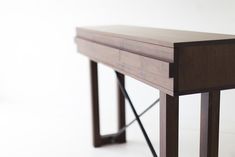 a close up of a wooden table on a white floor with no one around it