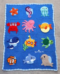 a crocheted blanket with various sea animals on it