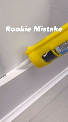 a yellow paint roller attached to the side of a wall with text reading rookie mistake