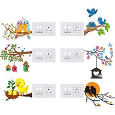 the birds are sitting on the tree branches and hanging from the light switch plates,