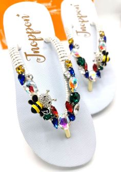 Description The beautiful rhinestone and customizable Flip Flops for the beach brides, bridesmaids, vacation, honeymoon or any occasion you desire to look gorgeous. Perfect in any outfit! Being unique and stunning on design, these flip flops must be your must-have item! The sandal is anti-slip, comfortable and durable as it is made from high quality rubber from the South of Thailand, where is famous for the best rubber tree. Moreover, the crystals are decorated on the sandal with effective adhes Bedazzled Sandals For Summer Beach, Bedazzled Sandals For Beach In Summer, Summer Bedazzled Sandals For Beach, Bedazzled Silver Sandals For The Beach, White Flip Flops For Beach Season Parties, Silver Bedazzled Sandals For Beach, Silver Bedazzled Sandals For The Beach, Summer Jeweled Open Toe Sandals, Spring Wedding Sandals With Bling