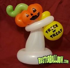 an inflatable balloon with a pumpkin on it and a trick or treat sign