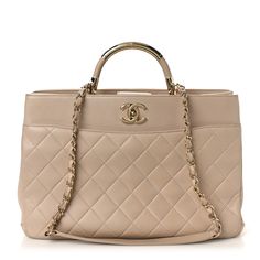 This is an authentic CHANEL Lambskin Large Carry Chic Shopping Tote in Beige. The bag features a looping light gold metal and beige leather top handle, a leather threaded light gold chain shoulder strap, and a patch pocket on the back. The full-facing flap opens with a CC turn-lock to a red leather interior with a zippered pocket. Chic Shop, Leather Thread, Shopping Tote, Leather Interior, Leather Top, Red Leather, Gold Chain, Patch Pocket