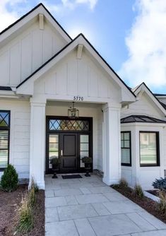 a white house with black doors and windows