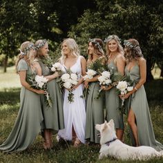 a group of women standing next to each other on top of a lush green field