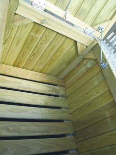 the inside of a wooden structure with metal bars