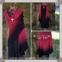 a red and black crocheted shawl hanging on a tree