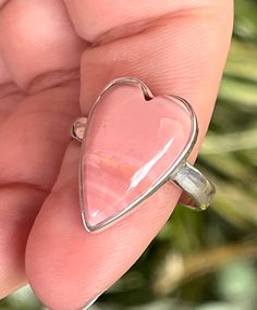 Natural, Australian, heart-shaped, pink Opal gemstone, ring, set in 925 Sterling Silver bezel setting. --Ring Size: 9.5. --Stone/Surface/Shape Measurements: Heart; 21mm x 14mm. --Band width: 3mm. Pink Heart-shaped Gemstone Ring, Heart-shaped Gemstone Ring For Valentine's Day, Pink Heart Cut Sterling Silver Ring, Opal Heart Ring, Labradorite Earrings, Stone Surface, Labradorite Pendant, Pink Opal, Opal Gemstone