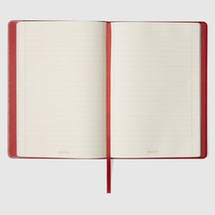 an open red notebook with lined pages