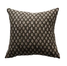 a black and white pillow with flowers on it